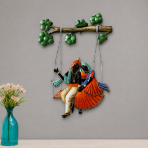 Metal wall hanging of Radha Krishna on jhula under tree branch – spiritual home decor